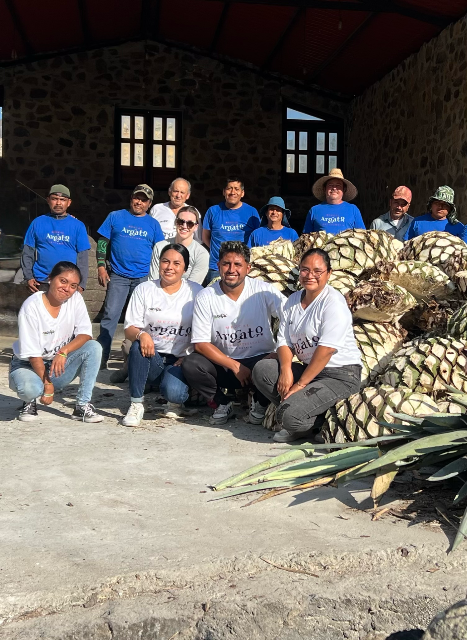 The Mezcal Argato team gathered together at the farm with harvested agave piñas