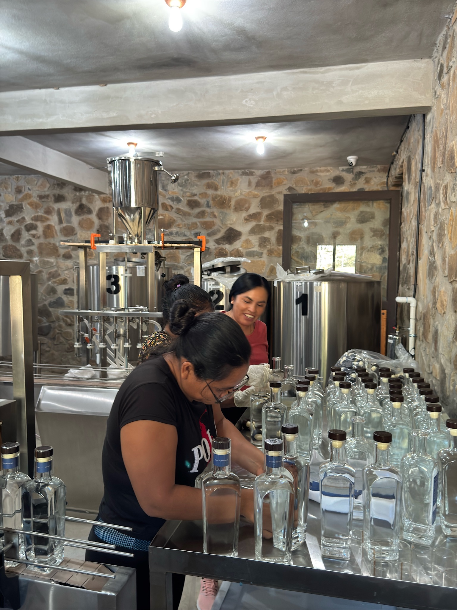 Mezcal Argato hand-labeled bottles and packaging process