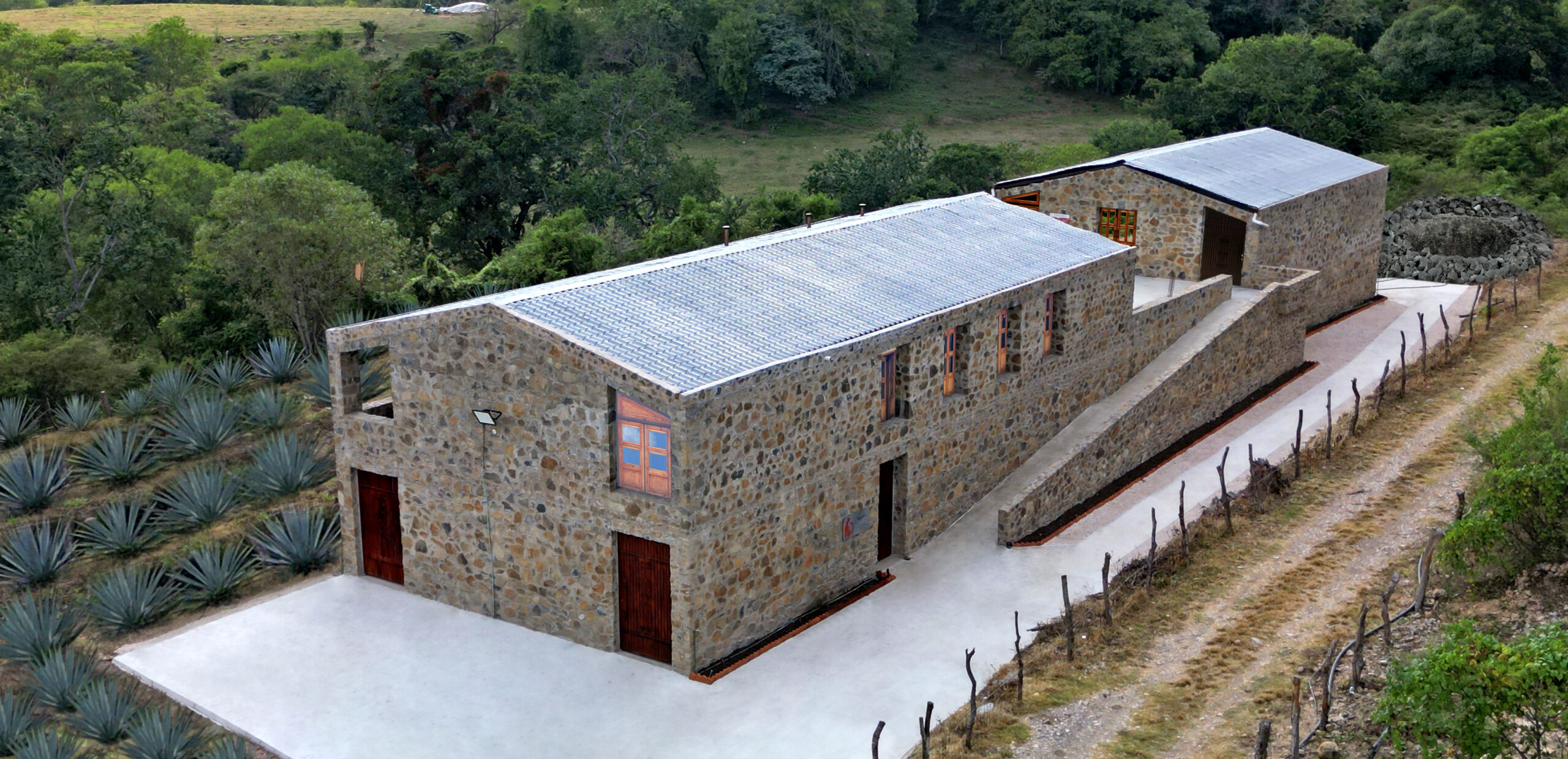 A building with stone walls and a metal roof.