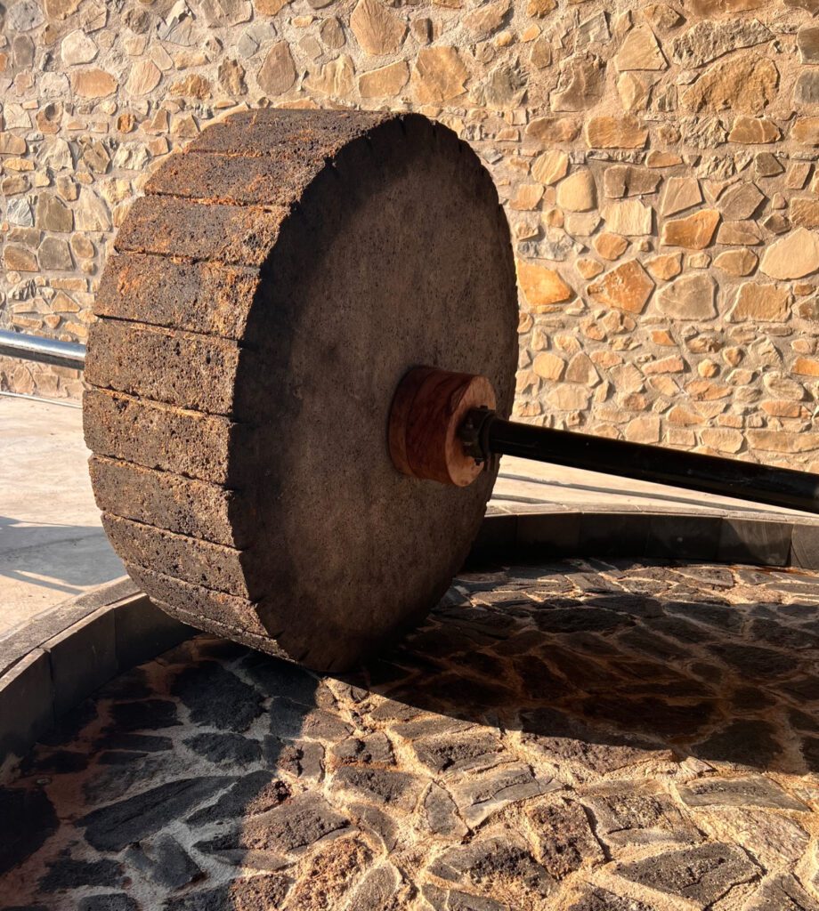 A wooden wheel with a stick on it