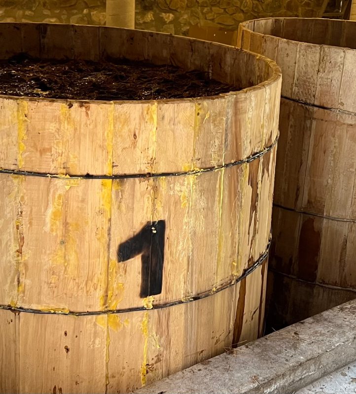 A wooden barrel with some sort of number on it